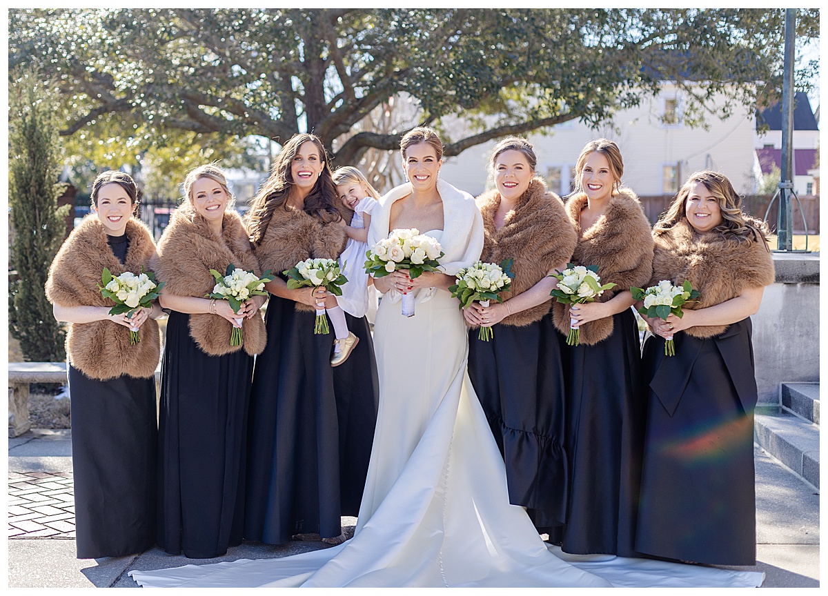 Black Bridesmaid dresses with brown fur bolero and white bouquets